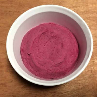 A bowl of mashed potato made from the variety Loowit. The potato looks like raspberry ice cream due to the high content of red pigments.